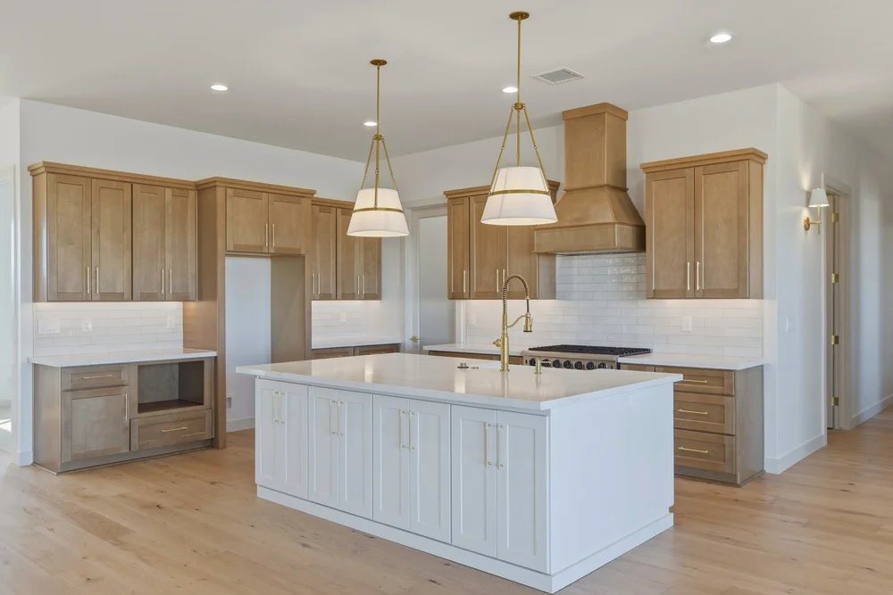 Custom kitchen cabinetry with a white island and warm wood perimeter cabinets, Prescott, AZ