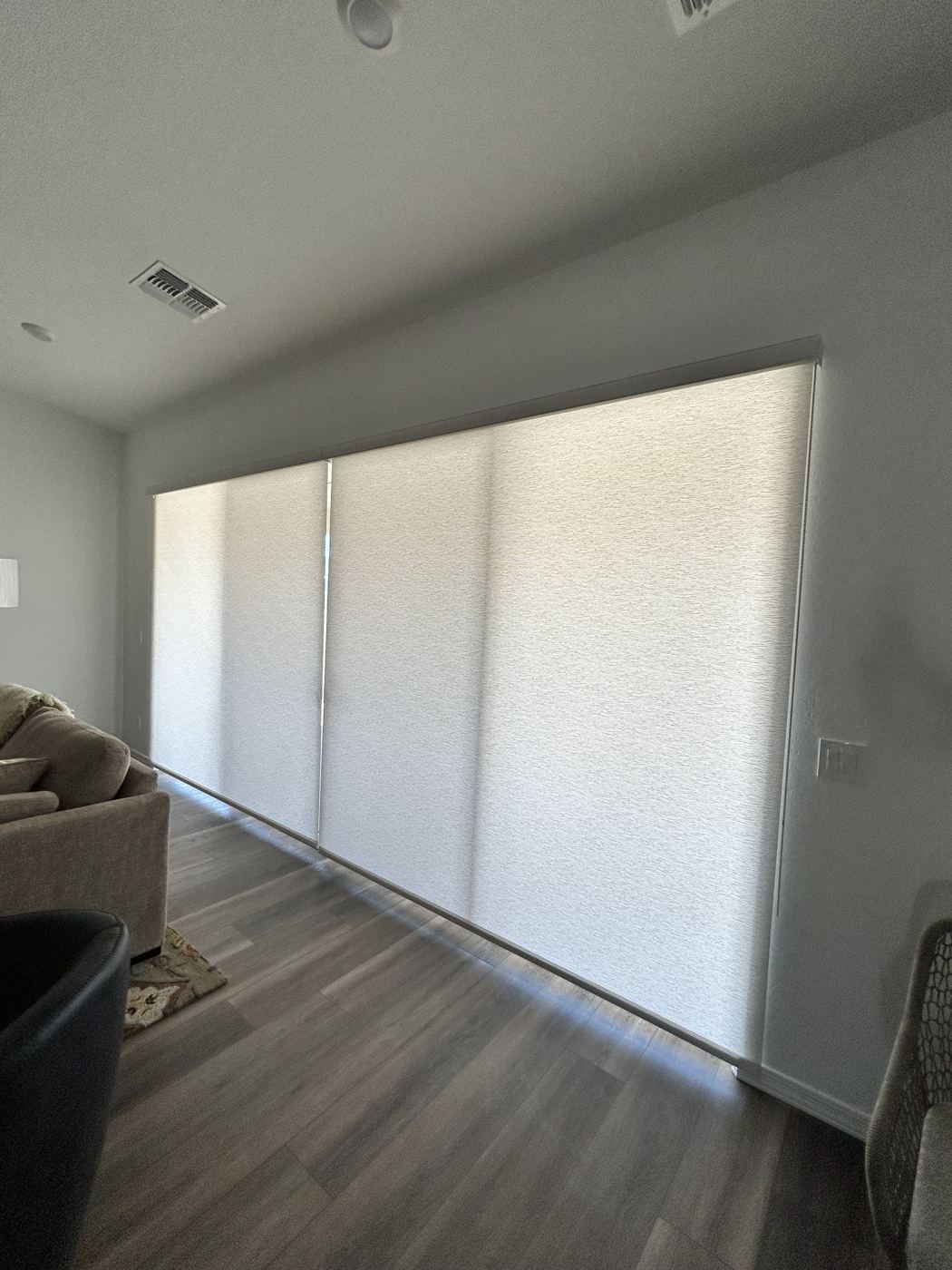 The same roller shades lowered, filling the room with soft, even daylight
